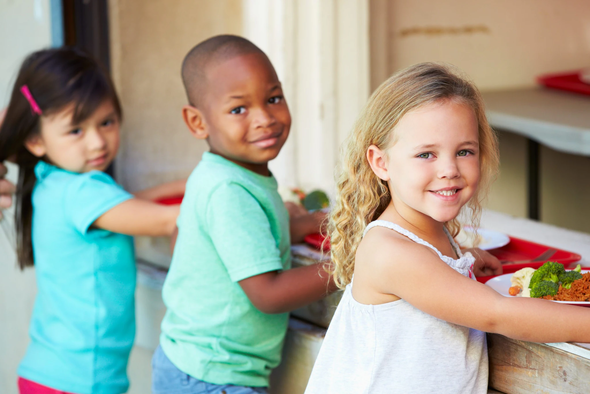 Elementary students collecting healthy school meals.