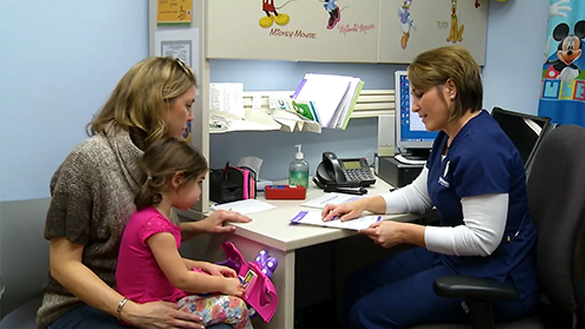 Mother and daughter visiting the doctor's office.