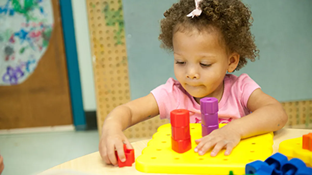 Girl playing with blocks.