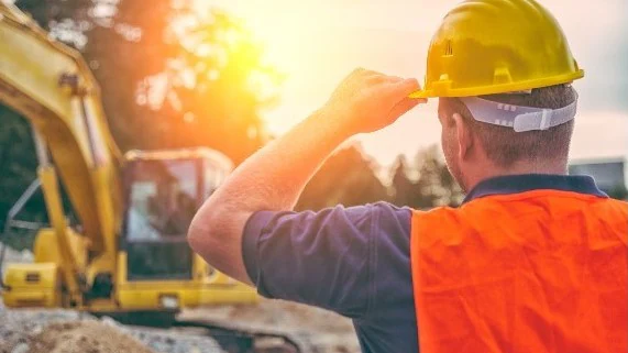 Construction worker looking at the worksite.